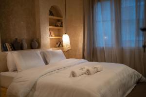 a bedroom with a bed with two babies on it at Biophilia Luxury Lofts in Beirut