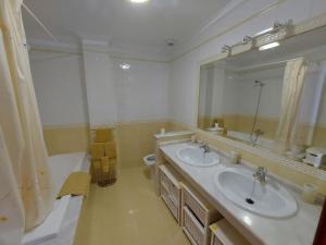 a bathroom with two sinks and a large mirror at INcostadamorte Vivienda Martinez in Cee +30 photos