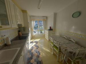 a kitchen with two tables and a sink at INcostadamorte Vivienda Martinez in Cee