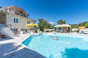 a swimming pool in front of a house at Paco's Superior Double Villa 15 in Oziás