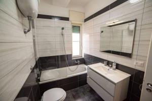 a bathroom with a sink and a toilet and a tub at Mare Fuori casa vacanze in Castellammare di Stabia +39 photos