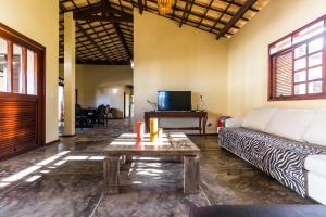 a living room with a couch and a coffee table at Sunset Beach Villas in Taíba