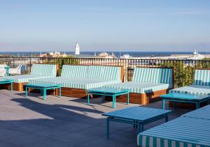 a row of benches sitting on top of a roof at Room Mate Valeria in Málaga