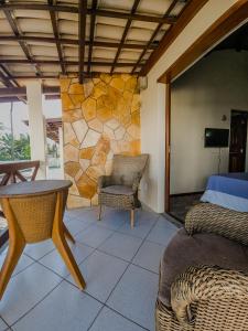 a room with a bed and a table and chairs at Sunset Beach Villas in Taíba +23 photos