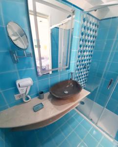 a blue bathroom with a toilet and a mirror at VisitPonza - Le Naiadi in Ponza