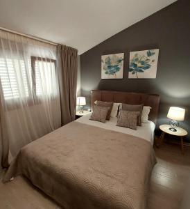 ein Schlafzimmer mit einem großen Bett und zwei Lampen in der Unterkunft Apartaments Victoria in Poreč