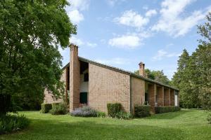 a brick building with two chimneys on top of it at Casa Mancini Monticiano - Holiday Villa in Monticiano