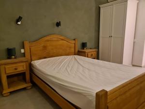 a bedroom with a wooden bed and two night stands at As056 Casa Amira - a modern house with pool in San Juan de los Terreros +11 photos