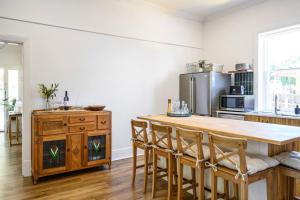 a kitchen with a large wooden table and chairs at 1930's Character Cottage - Beautifully Restored in McLaren Vale