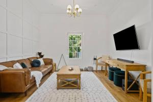 a living room with a couch and a table at 1930's Character Cottage - Beautifully Restored in McLaren Vale
