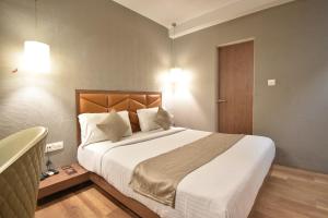 Postel nebo postele na pokoji v ubytování The Aarya A Smart Business Hotel