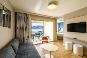 a living room with a couch and a view of the ocean at Best Western Plus Ajaccio Amirauté in Ajaccio
