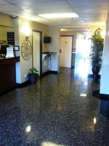 an empty lobby of a office with potted plants at Super 8 by Wyndham Bridgeview/Chicago Area in Bridgeview