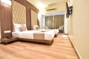 Postel nebo postele na pokoji v ubytování The Aarya A Smart Business Hotel