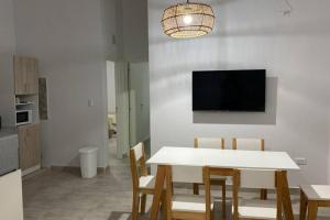 a dining room with a white table and chairs at Cerros de Cafayate, Casa Nº2 in Cafayate