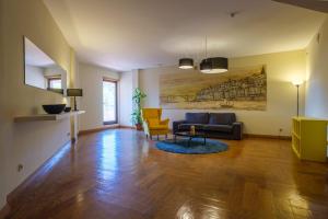 a living room with a couch and a chair at Vilar Oporto Hotel in Porto