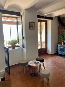 a living room with a table and two stools at El Portal de Vilafamés in Vilafamés