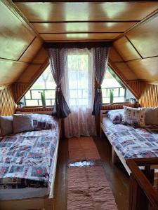 a room with two beds and a window at Chata u tří borovic in Chvalatice
