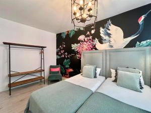 a bedroom with a bed and a wall with flowers at Apartamentos Realejo Campo del Príncipe 3000 in Granada +43 photos