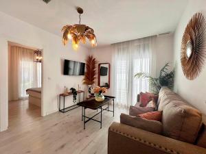 a living room with a couch and a table at Apartamentos Realejo Campo del Príncipe 3000 in Granada
