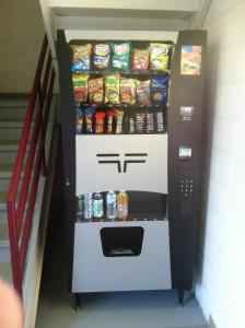 a vending machine filled with chips and soda at Super 8 by Wyndham Bridgeview/Chicago Area in Bridgeview