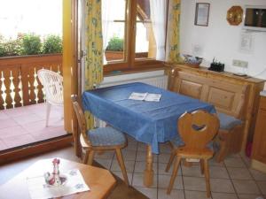a kitchen with a table with a blue table cloth on it at Appartement in Wittenschwand mit Garten und Grill und Panoramablick in Wittenschwand