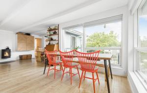 a dining room with a table and four chairs at 3 Bedroom Beautiful Home In Ølsted in Ølsted