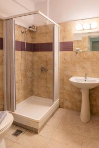 a bathroom with a shower and a sink at Fontana Luxury Rooms in Mytilini +14 photos