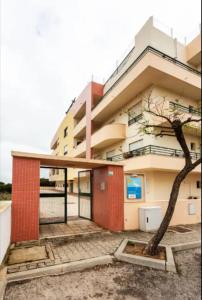 a building with a tree in front of it at BLife RYA private rooms - Airport stay in Faro