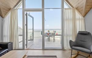 a living room with a large glass door leading to a deck at Lovely Home In Hasle With Wifi in Hasle