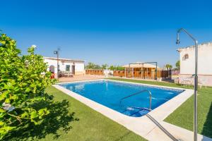 a swimming pool in the yard of a house at Casa Rural Carmo in Carmona