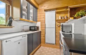a kitchen with a white refrigerator and a sink at 3 Bedroom Cozy Home In Eskebjerg in Eskebjerg +10 photos