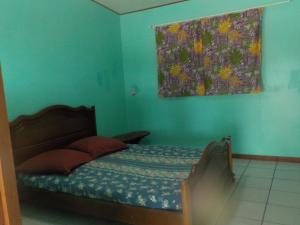 a bedroom with a bed with a painting on the wall at Camping Hiva Plage in Parea