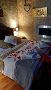 um quarto com uma cama com flores vermelhas em L'antico vicolo em Nunziata