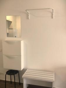 a white room with a bench and a mirror at Mamaia SUNNY LOFT in Mamaia