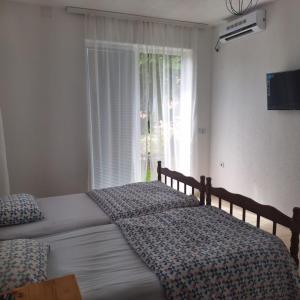 a bedroom with two beds and a window at Yahya Rooms in Ohrid