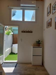a living room with a door and a window at Le Studio de L'Ayguade - Plage à 100 m in Hyères