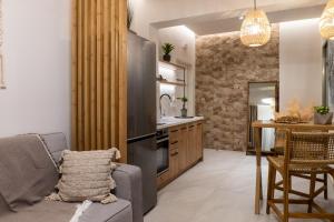 a kitchen and living room with a couch and a table at Nikos Studios Apts & Suites in Keri