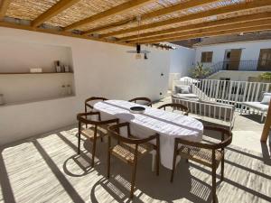 a patio with a table and chairs on a balcony at La Maison De Ville - Piscine & SPA in Sète