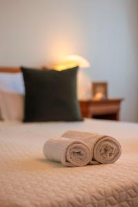 a pair of rolled up towels on a bed at Septimia Hotels & Spa Resort in Odorheiu Secuiesc