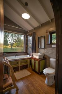 a bathroom with a tub and a toilet and a sink at Kokopelli farm in Magaliesburg