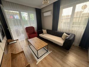 a living room with a couch and a table at The rooms hotel in Kumbağ