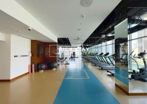 a gym with rows of treadmills and exercise equipment at Phenomenal 1BR at Marina Gate 2 in Dubai Marina by Rich Stay in Dubai