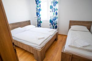 a bedroom with two beds and a window at Apartman A&S in Tomislavgrad