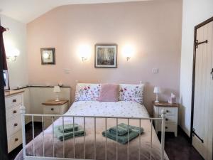 a small bedroom with a bed and two night stands at Sheepfold Cottage Dulverton in Dulverton