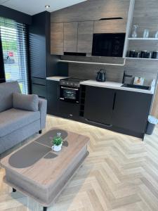 a living room with a couch and a coffee table at luxury hot tub glamping apartment in Ireleth