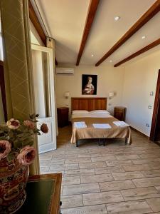 a bedroom with a bed and a table in a room at LoryLu in Tropea