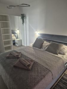 a bedroom with a large bed with towels on it at Sonia Pearl Apartament z parkingiem in Sianozety