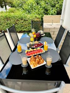 a table with breakfast foods and drinks on it at House MARIJA in Novalja
