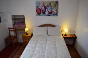 Uma cama ou camas num quarto em Barrio Inka B&B